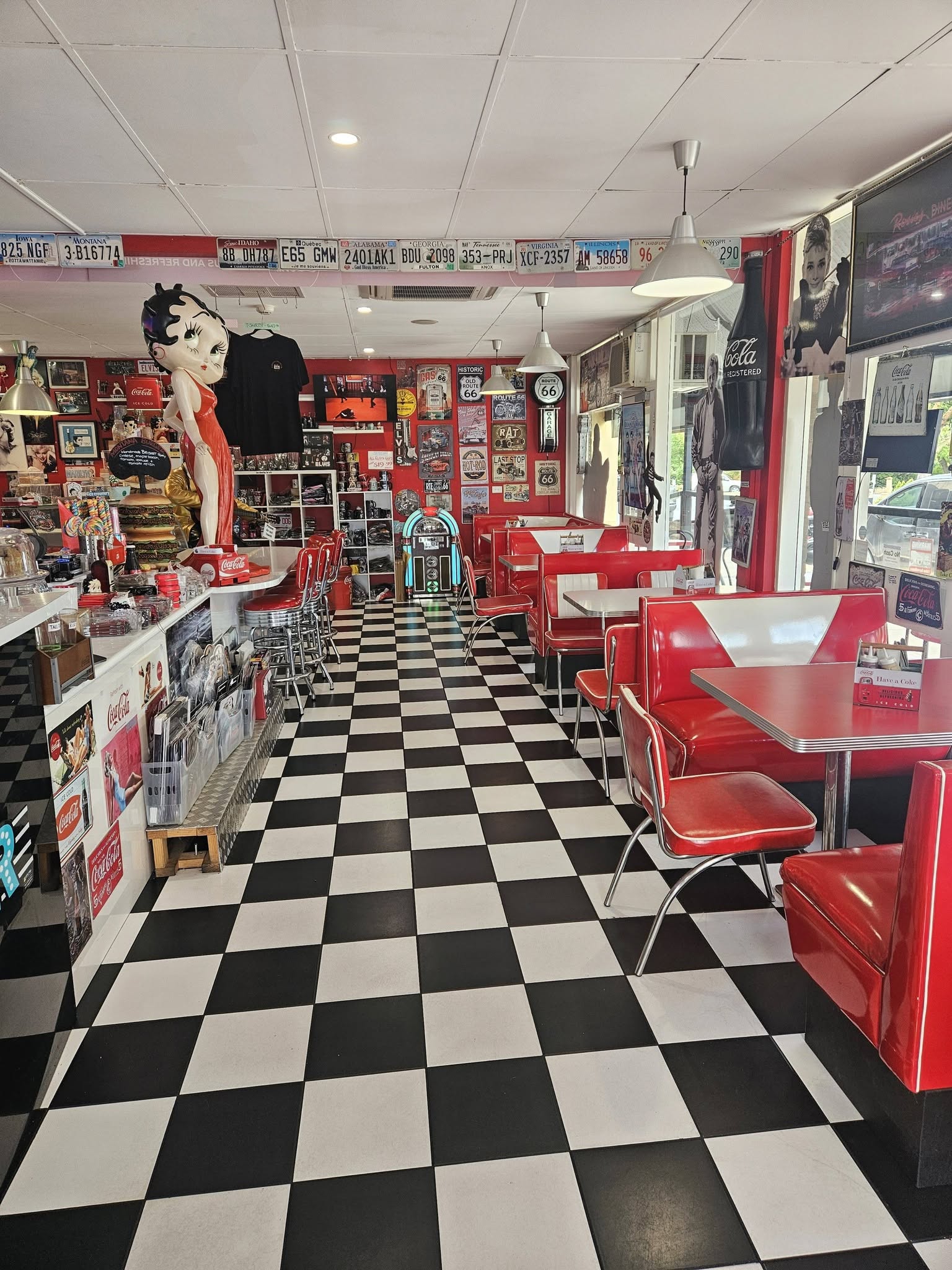 Chrome diner counter lined with red-topped stools