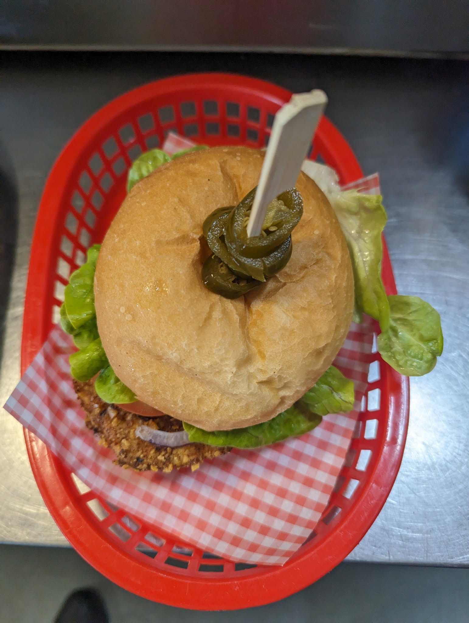 Signature diner burger stacked high with lettuce, tomato and cheese