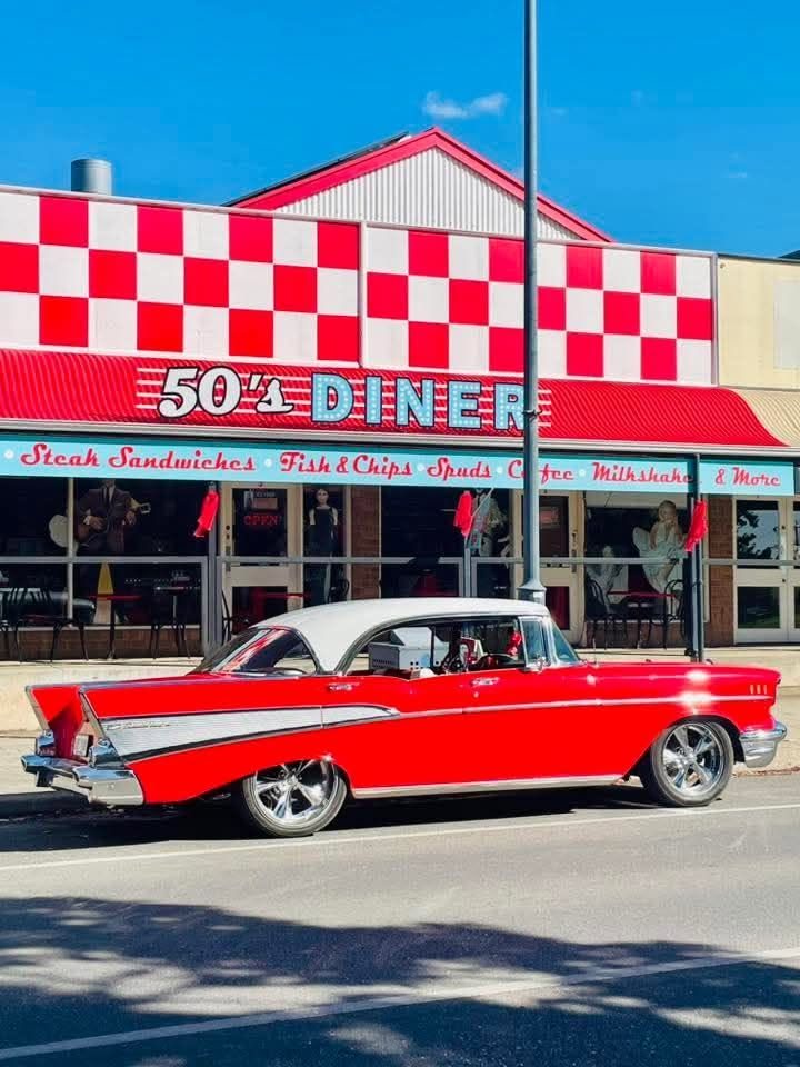 The front of Barossa 50's Diner on Murray Street, Tanunda — red and white checkered facade with a classic car parked out front